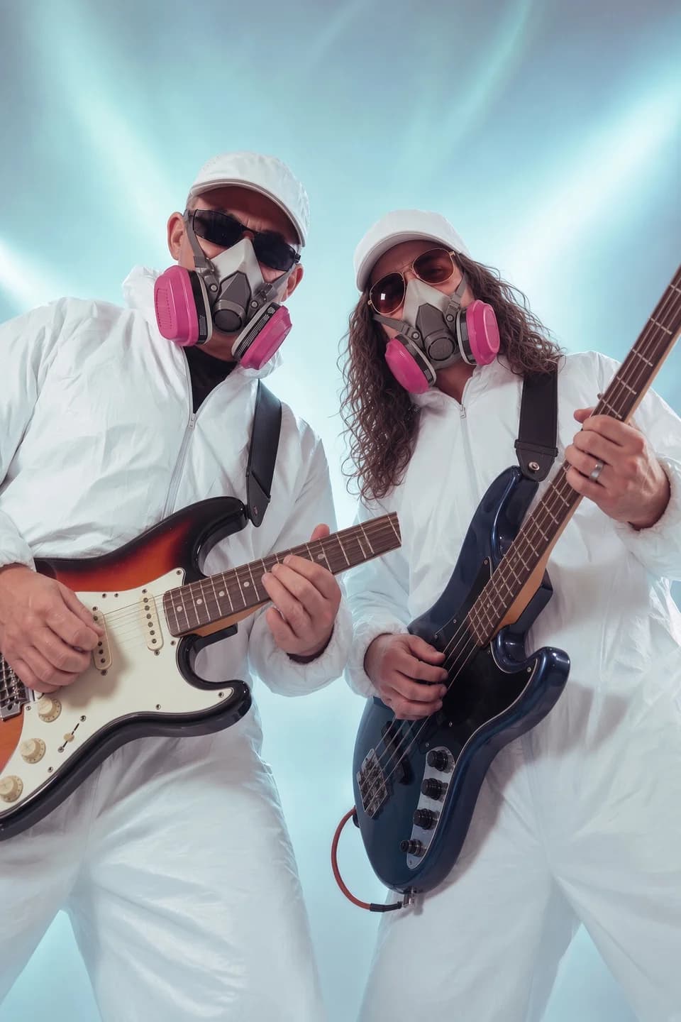 The BrushStrokes duo with guitars, white hats, and painting suits